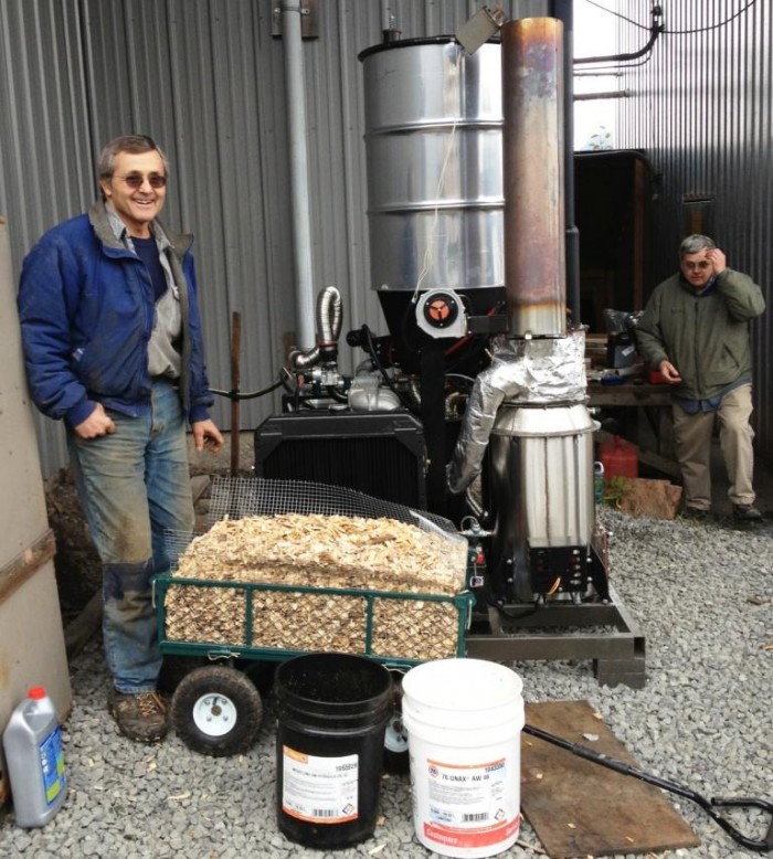 Wes Tyler, left, stands by a new wood gasifier at Icy Straits Lumber in Hoonah. John Hillman of the Hoonah Indian Association is on the right