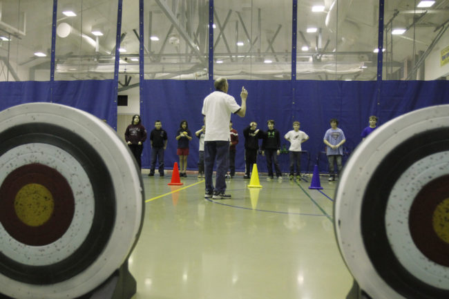 After school archery instructor Dick Fagnant teaches Dzantik'i Heeni Middle School students how to recognize their dominant eye before using the bow and arrows.