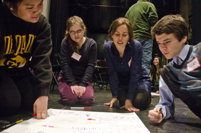 Hilary Young talks to one of the groups about the ideas on their poster.