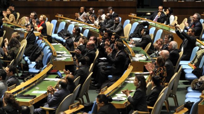 Delegates to the United Nations General Assembly applaud the passage of the first U.N. treaty regulating the international arms trade on Tuesday. Timothy A. Clary /AFP/Getty Images