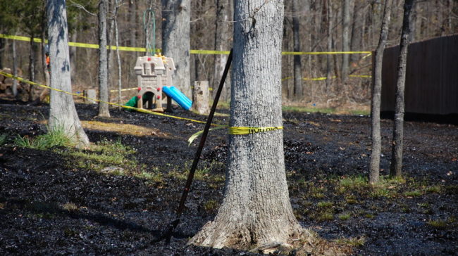 Oil covers the ground around a slide in Mayflower, Ark., on April 1, days after a pipeline ruptured and spewed oil over lawns and roadways. Jeannie Nuss/AP