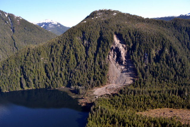 Redoubt_Slide The slide at the head of Redoubt Lake, photographed in late May. The lake itself is to the left; the new lake is flooding the wooded area to the right. At present, the extent of the flooding is about 55 acres. (USFS photo)
