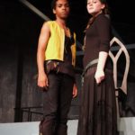 Two actors pose onstage