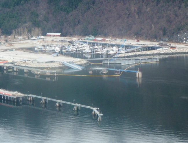 Oil containment boom remains in place around the sunken Skagway ferry terminal dock. (Photo courtesy Kirk Miller, Alaska DOT&PF. 