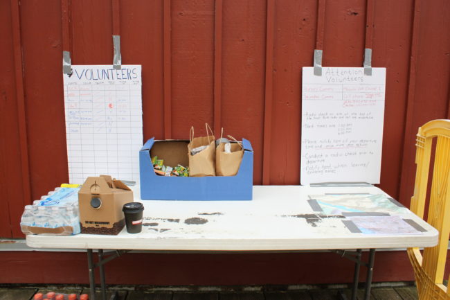 The volunteer search table is located behind the Mt. Roberts Tramway building. Volunteers are needed. The team will meet up Friday, Saturday and Sunday morning at 9 a.m. Volunteers can also contact Luke Holton on Facebook. (Photo by Lisa Phu/KTOO)