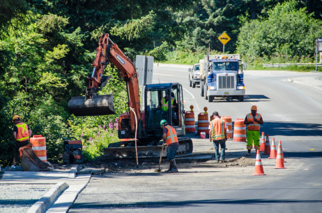 Crews finish construction around water pipe access points. (Photo by Heather Bryant/KTOO)