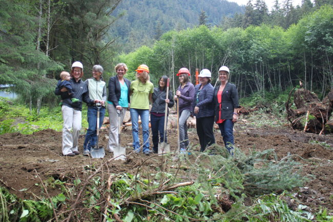 AWARE staff, board members and Rep. Cathy Munoz stand on land being cleared for the new transitional housing facility. (Photo by Lisa Phu/KTOO)