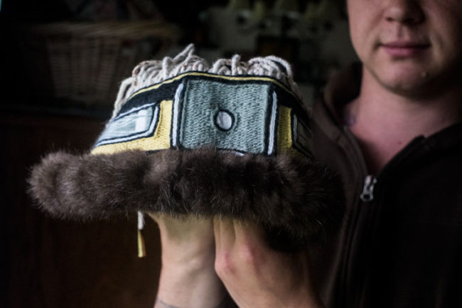 A man holds a Chilkat head band