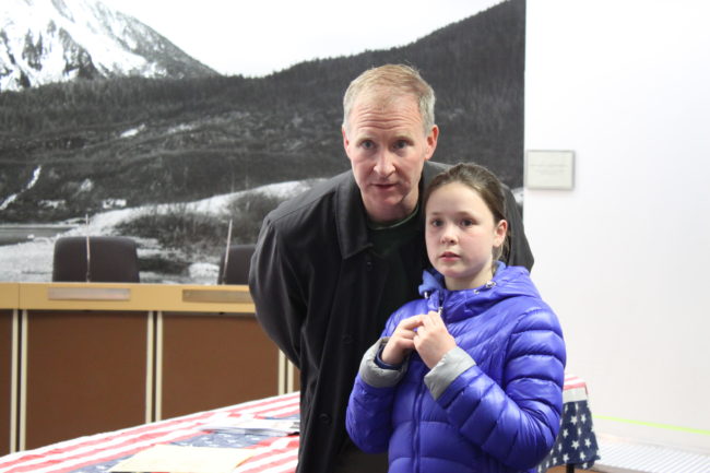 Brian Holst watches results come in at city hall with daughter Jasmin. (Photo by Lisa Phu/KTOO)