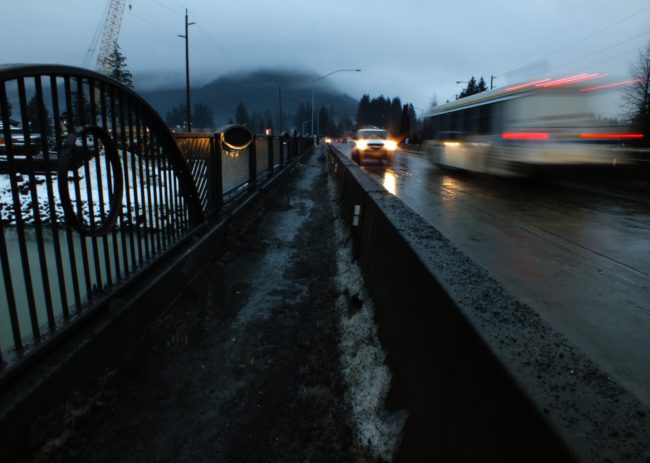 View of railing and traffic crossing the first phase of the Brotherhood Bridge replacement project. (Photo by Matt Miller/KTOO)