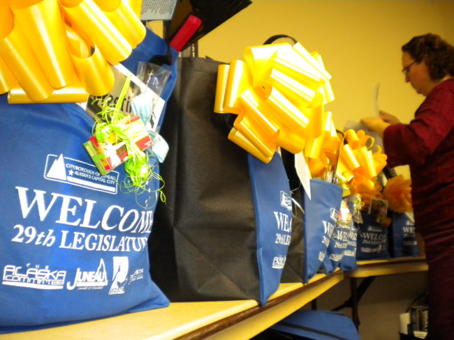 Juneau's Deputy City Clerk Beth McEwen stuffs gift baskets that will be given out to state lawmakers at the 30th annual Legislative Welcome Reception at Centennial Hall. (Photo by Kevin Reagan/KTOO)
