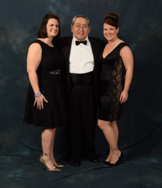 Sam Kito Jr. and two beautiful women.  Kito wore a suit jacket with lovebirds embroidered on the lapel by Hydaburg artist Dorothy Grant.  (Photo by Skip Gray/KTOO)