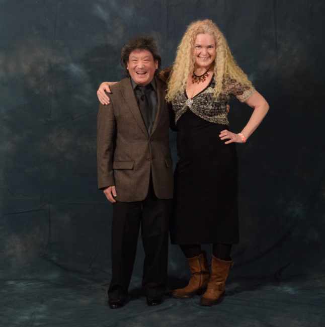 Steve Tada and Joanie Waller.  "I got a bunch of girlfriends some brooches for Christmas and one of them didn't come to the party, so I put it on today," said Waller. "I thought if I saw her here, I'd give it to her." (Photo by Skip Gray/KTOO)