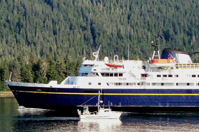 A Petersburg fishing boat passes the ferry Taku near the entrance of Wrangell Narrows in August, 2013. (Ed Schoenfeld/CoastAlaska News)