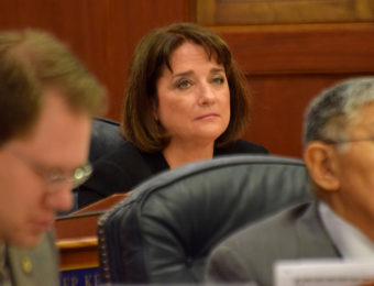 Rep. Lora Reinbold, R-Eagle River, listens as the Alaska House of Representatives adopts a Committee on Committees report stripping her of membership on all but one committee, March 16, 2015. It was a consequence of breaking a majority caucus rule by voting against the operating budget on March 12. (Photo by Skip Gray/360 North)