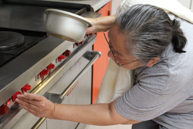 Siouxbee Lindoff heating up yeast to make Easter bread (Elizabeth Jenkins/KTOO)