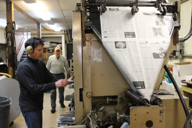 James Poulson and his father Thad operate the printing press