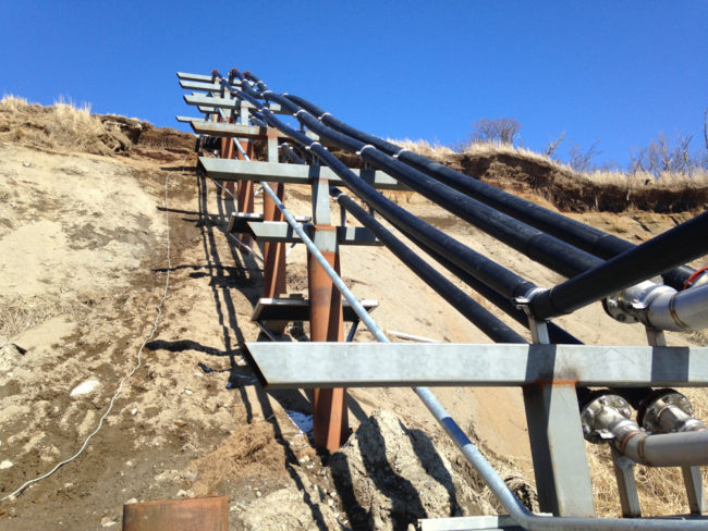 Metal tubes run up a hill