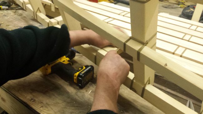Mitch Keplinger tightens twine. (Photo by Kayla Desroches, KMXT – Kodiak)