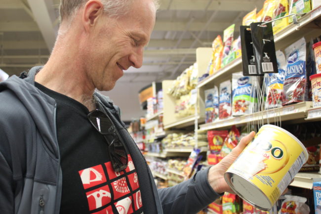 Børge Ousland finds a package of dry milk that's enough for both him and Colliard. Otherwise, they shop separately for their individual needs. (Photo by Lisa Phu/KTOO)