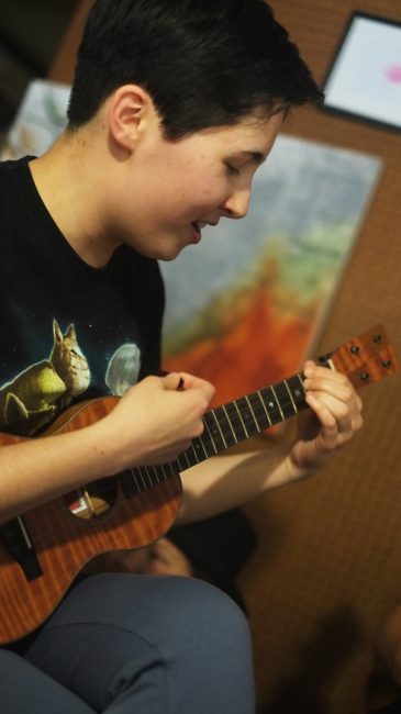 Songwriter Molly Lewis plays her ukulele in the Kindred Post loft on May 19. (Photo by Annie Bartholomew/KTOO)