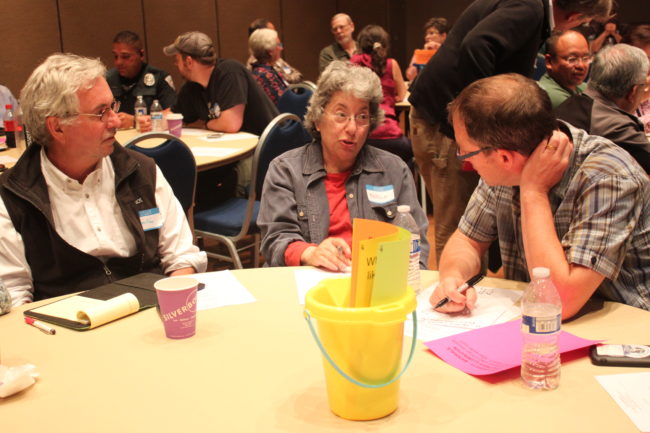 Greg Fisk, Margo Waring and Chris Mertl discuss concepts for improving Franklin and Front streets during a community meeting Wednesday night. (Photo by Lisa Phu/KTOO)