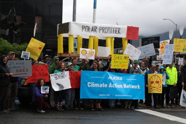 Some of the signs were taped to kayak paddles. A nod to the Kayaktavists in Seattle. (Photo by Elizabeth Jenkins/KTOO) 
