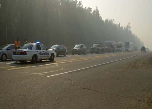 Troopers stop traffic on the Parks Highway as part of traffic control during the Sockeye Fire. (Photo by John Norris - Alaska Public Media)