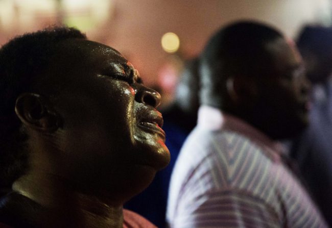 Lisa Doctor joins a prayer circle early Thursday down the street from the Emanuel AME Church, following a shooting on Wednesday night in Charleston. (Photo by David Goldman/AP)