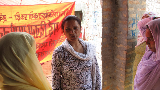 Saroj listens to the complaints and concerns of other cooks and kitchen help during a union meeting. Rhitu Chatterjee for NPR