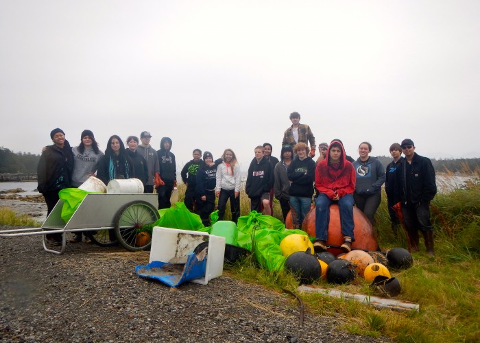 9-2014 Students and staff from Sitka's Pacific High School pose with tsunami and other debris collected on Biorka Island in 2014. (Photo Courtesy Sitka Sound Science Center)