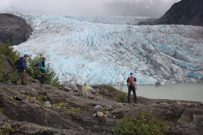 Colton Tersteeg, his parents Jeff and Diana, and their dog Buddy hiked to the glacier on Friday and built some of the rock cairns that the signs will be planted in. (Photo by Lisa Phu/KTOO)