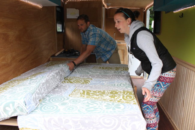 The bench in the "living room area" also doubles as a bed. (Photo by Elizabeth Jenknis/KTOO) 
