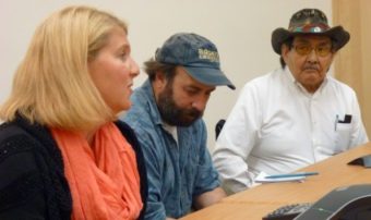 Salmon Beyond Borders' Heather Hardcastle reacts to the week's mining meetings while Rivers Without Borders' Chris Zimmer, center, and the Douglas Indian Association's John Morris listen. (Photo by Ed Schoenfeld/ CoastAlaska News)