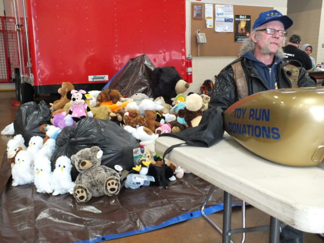 Panhandlers MC Treasurer Mark "Brillo" Chitty accepts donations at Sunday's Toy Run. (Photo by Matt Miller/KTOO)