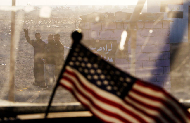 Iraqis wave at a departing U.S. armored vehicle from the 3rd Brigade Combat Team, 1st Cavalry Division. The vehicle was part of the last U.S. military convoy to leave Iraq on Dec. 18, 2011. Iraq was relatively stable at the time the U.S. pulled out, but the rise of the Islamic State would lead President Obama to launch an air campaign in Iraq in August 2014. Lucas Jackson-Pool/Getty Images