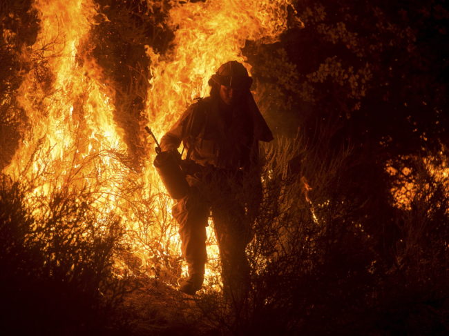 A firefighter lights a backfire while battling the Butte Fire near San Andreas, Calif., on Saturday.