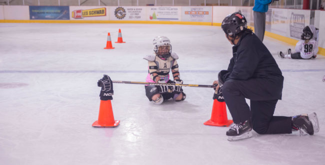 Darryl Tseu is greeted by a smiling Brealle Ward during JDIA’s Learn to Play afternoon at Treadwell Ice Arena. (Photo by Steve Quinn)