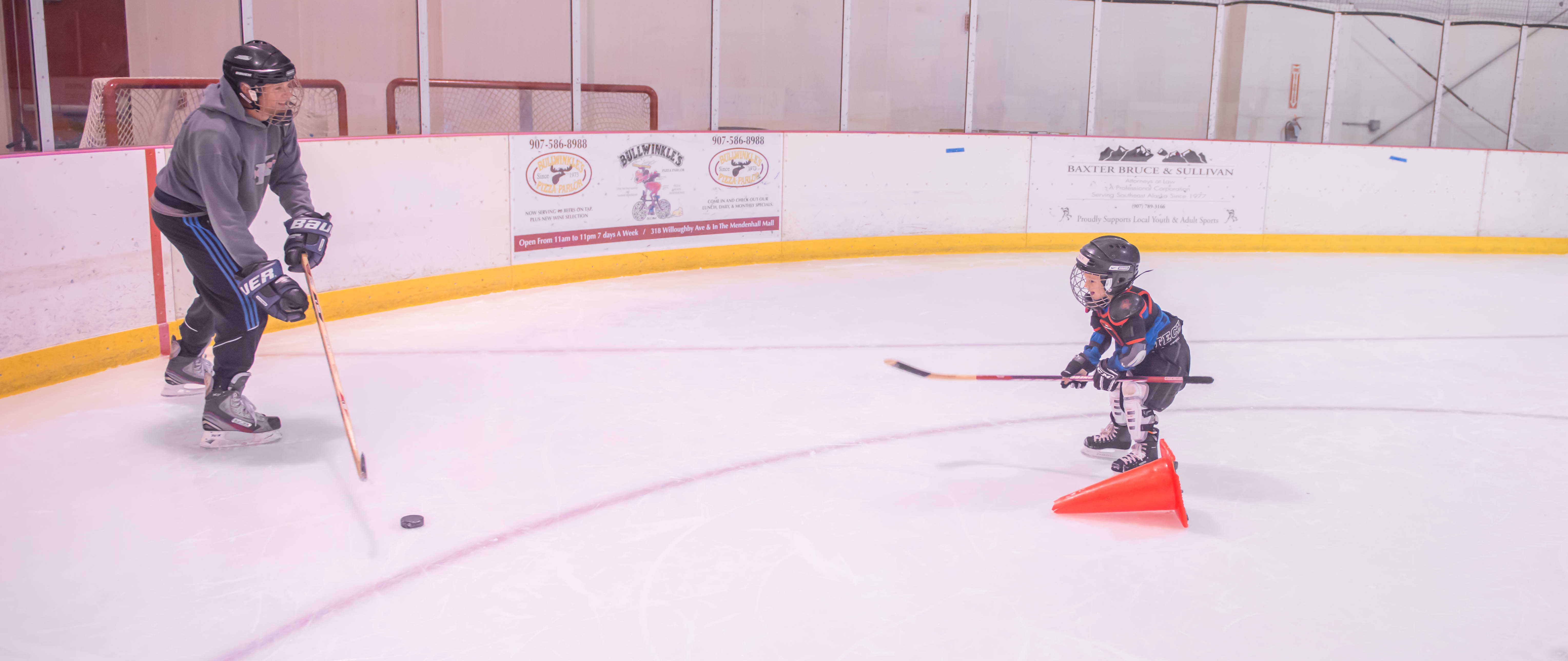 Randy Host (left) enjoys some ice time with his son Mack at JDIA’s Learn to Play afternoon at Treadwell Ice Arena. (Photo by Steve Quinn)