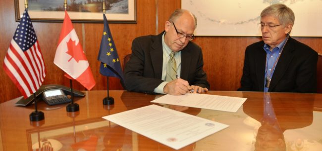 Gov. Bill Walker signs a memorandum of understanding with British Columbia Wednesday as Lt. Gov. Byron Mallott watches. (Photo courtesy governor's office)
