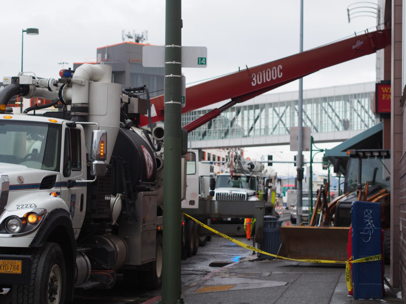 Municipal Light and Power crews work on digging through cement to reach a malfunctioning transformer knocked out during the earthquake, interrupting power to the 5th Avenue Mall. (Photo by Zachariah Hughes/KSKA)