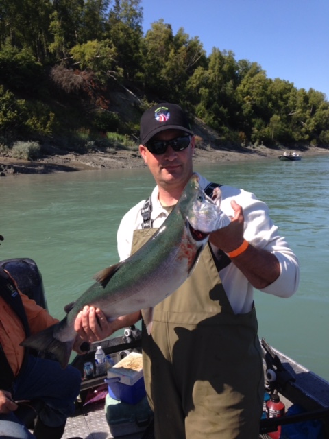 Staff Sergeant Joshua Schneiderman, a forward observer stationed with the 4th Brigade 25th Infantry Division, holding a silver salmon caught during a Wounded Warriors event. (Photo courtesy of Joshua Schneiderman)