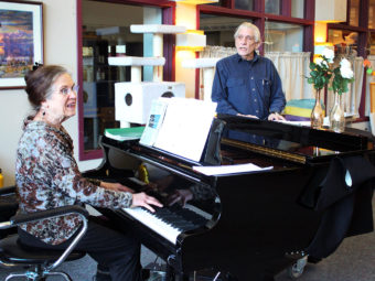 Jacque Farnsworth and Jack Brandt lead a music activity at the Juneau Pioneers’ Home. Farnsworth says she’s been singing and playing piano there since 2003. (Photo by Lisa Phu/KTOO)