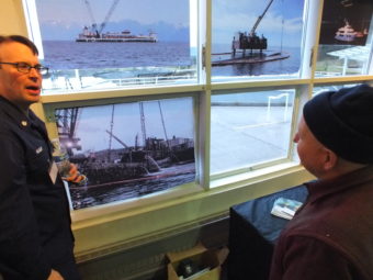 Coast Guard Cmdr. Patrick Hilbert, incident commander for the Challenger operation, talks to a Juneau resident at Tuesday's open house. (Photo by Matt Miller/KTOO