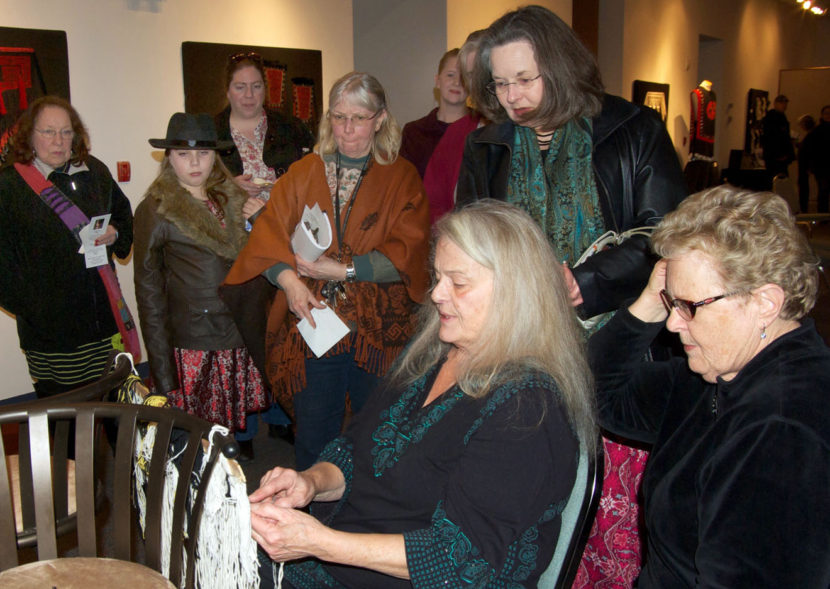 Kay Field Parker demonstrates Ravenstail techniques at the opening reception for her art show, “Traditional and Contemporary Ravenstail Weavings,” at the Kenai Visitors and Cultural Center in January. (Photo by Jenny Neyman/KDLL)