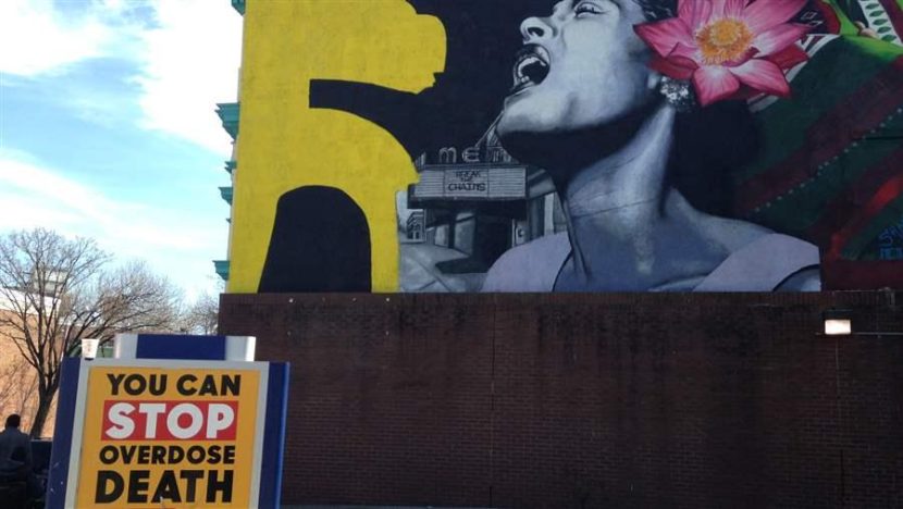 A sign for a Baltimore overdose reversal program. To stem the death toll in the opioid epidemic, cities and states, as well as the federal government, are promoting greater use of the overdose rescue drug naloxone. (The Pew Charitable Trusts)