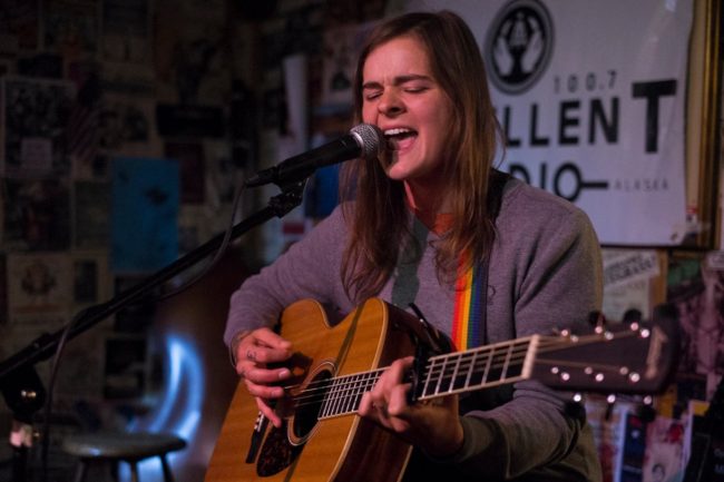 A picture of Liz Snyder Playing acoustic guitar.