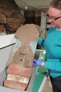 Hayley Chambers displays a fragment from the Coast Guard pole. (Photo by Maria Dudzak/KRBD)