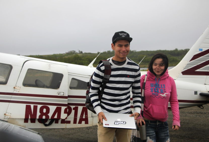 Peter Geffe and Amy Angasan deplane on their way to school on a breezy May morning. (Photo by Hannah Colton/KDLG)