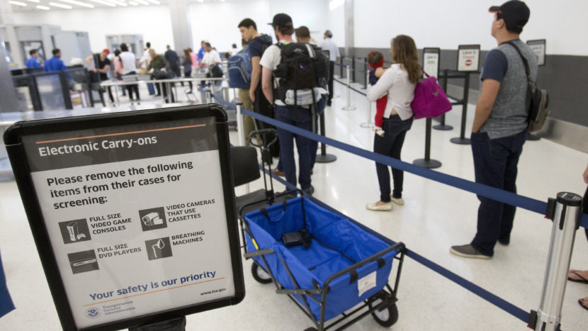 Faced with the prospect of long wait times at airports this summer, Homeland Security is boosting its checkpoint staffing. In this photo from December, passengers line up to go through security at the Fort Lauderdale-Hollywood International Airport. Wilfredo Lee/AP